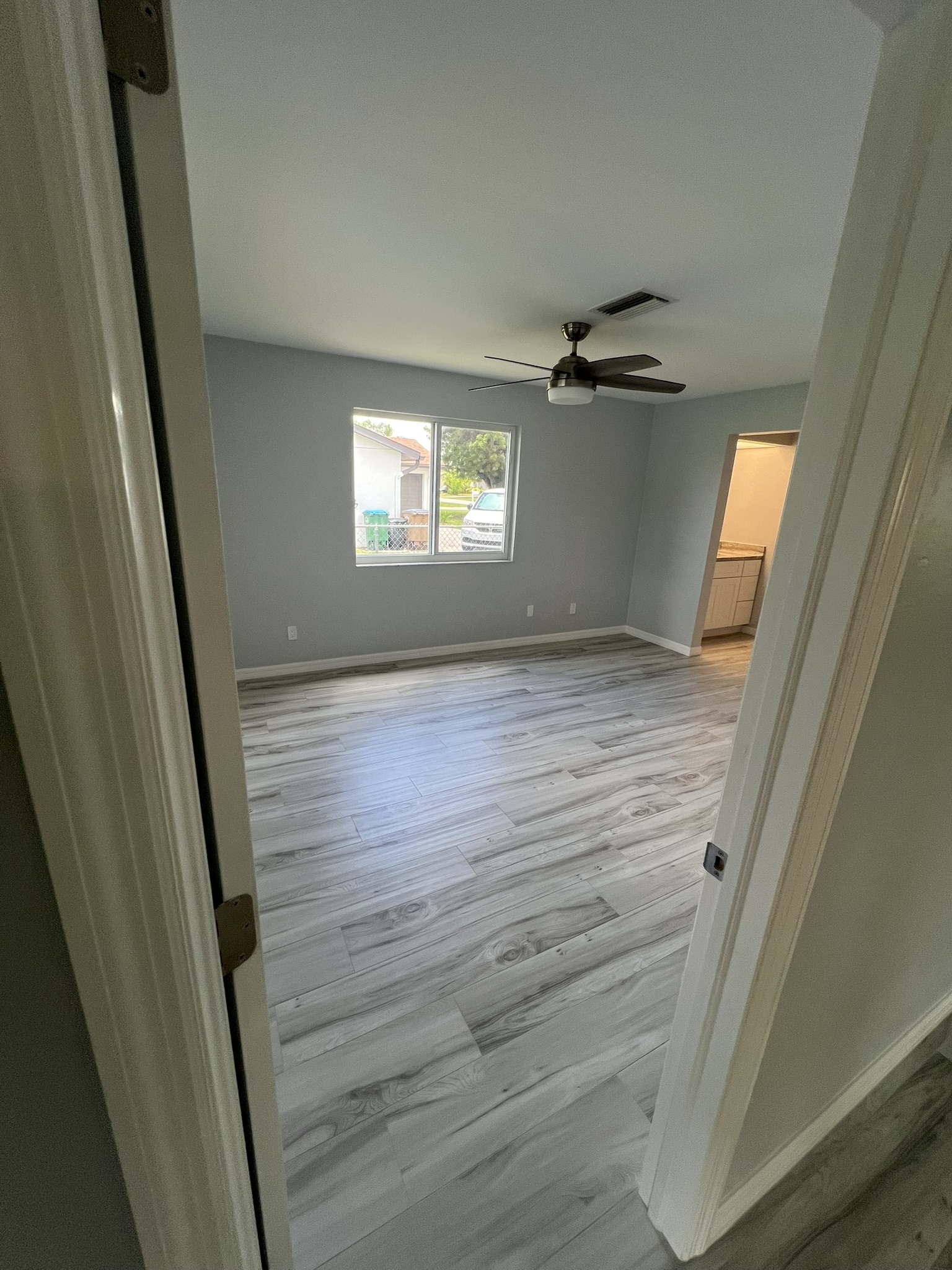 The floors were replaced throughout the home with elegant wood-look ceramic tile in a 6″ x 48″ plank style