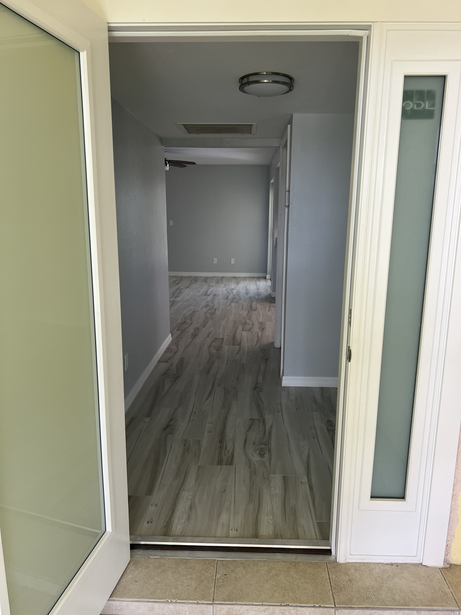 Front door open with view of interior new flooring